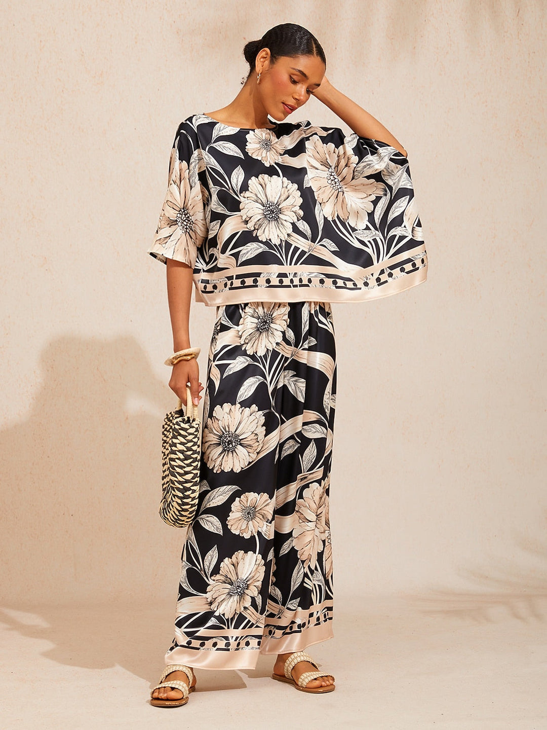 Womens silky satin floral blouse in glacier blue featuring an asymmetrical hem and dolman sleeves, perfect for stylish casual wear. 4