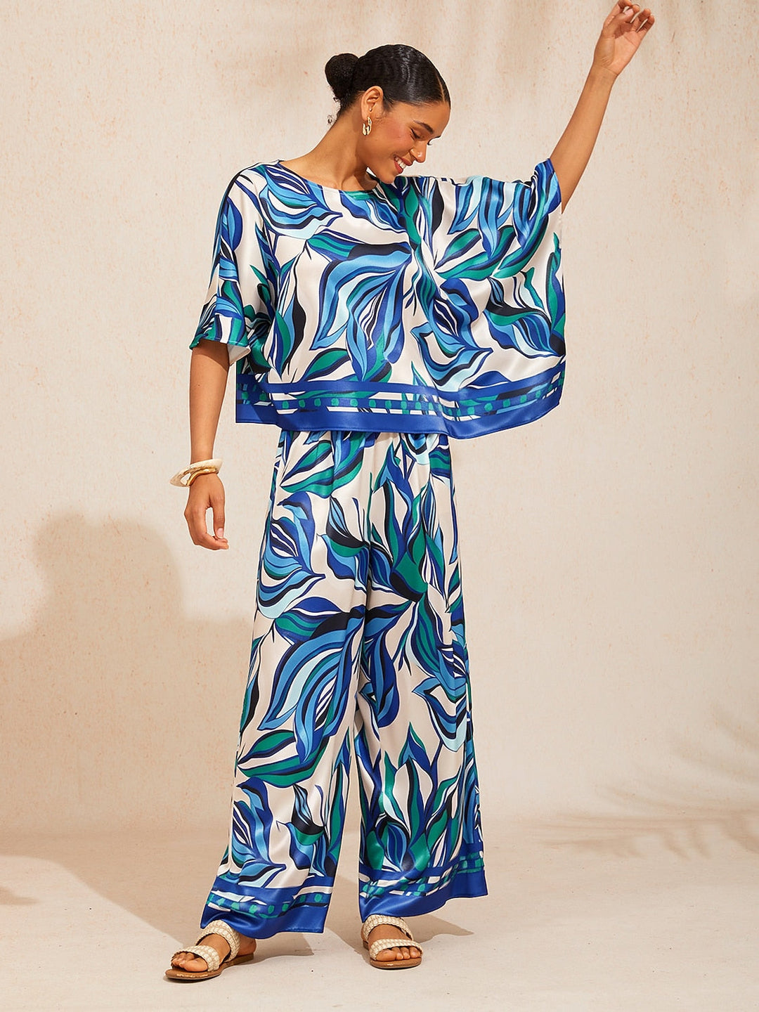Womens top featuring an asymmetrical hem and kimono sleeves, made of silky satin with a vibrant tropical print, perfect for stylish summer outfits. 13