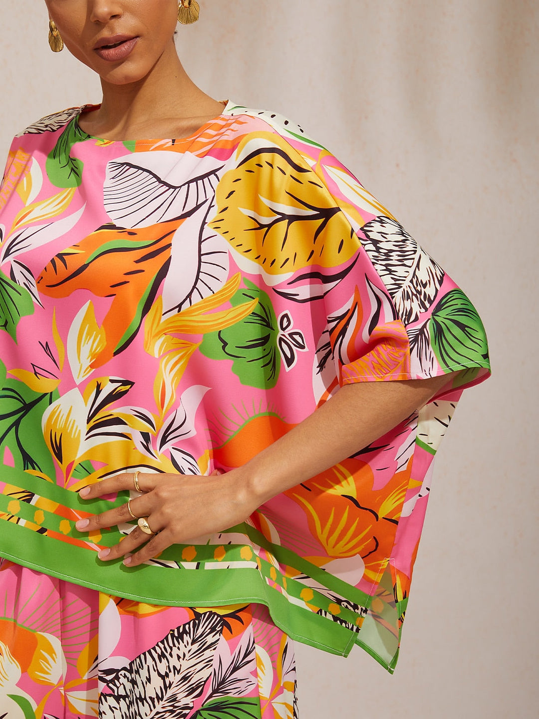 Womens top featuring an asymmetrical hem and kimono sleeves, made of silky satin with a vibrant tropical print, perfect for stylish summer outfits. 2