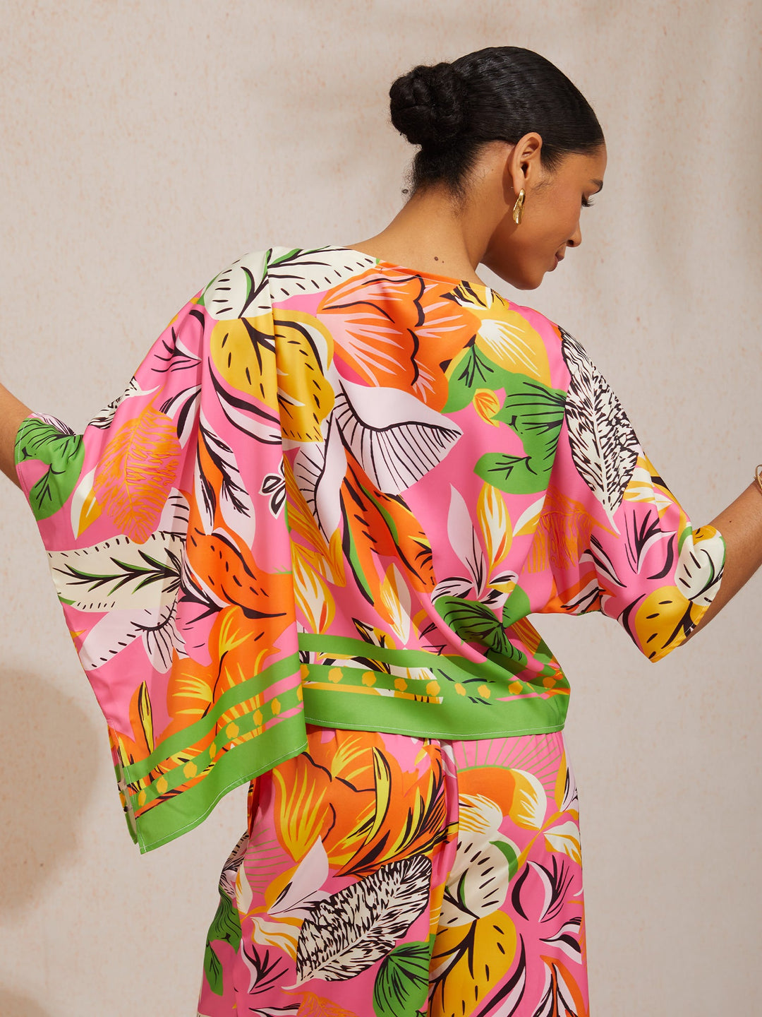 Womens top featuring an asymmetrical hem and kimono sleeves, made of silky satin with a vibrant tropical print, perfect for stylish summer outfits. 5